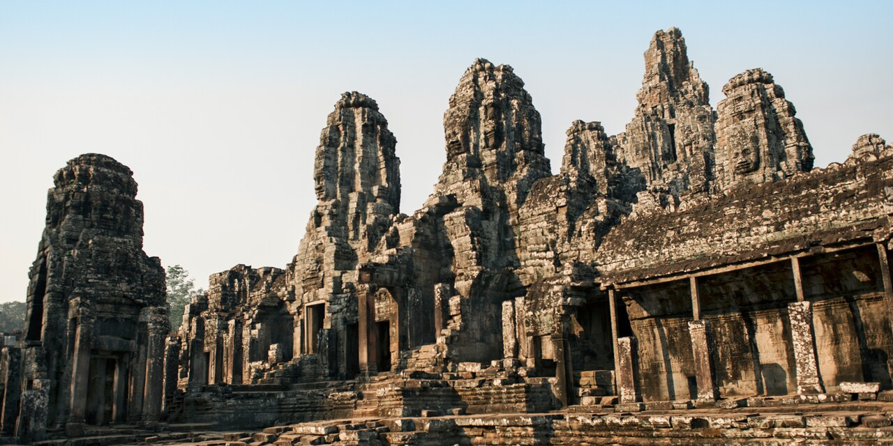 A stone courtyard in front of buildings at the Angkor Wat Archaeological Park A stone courtyard in front of buildings at the Angkor Wat Archaeological Park