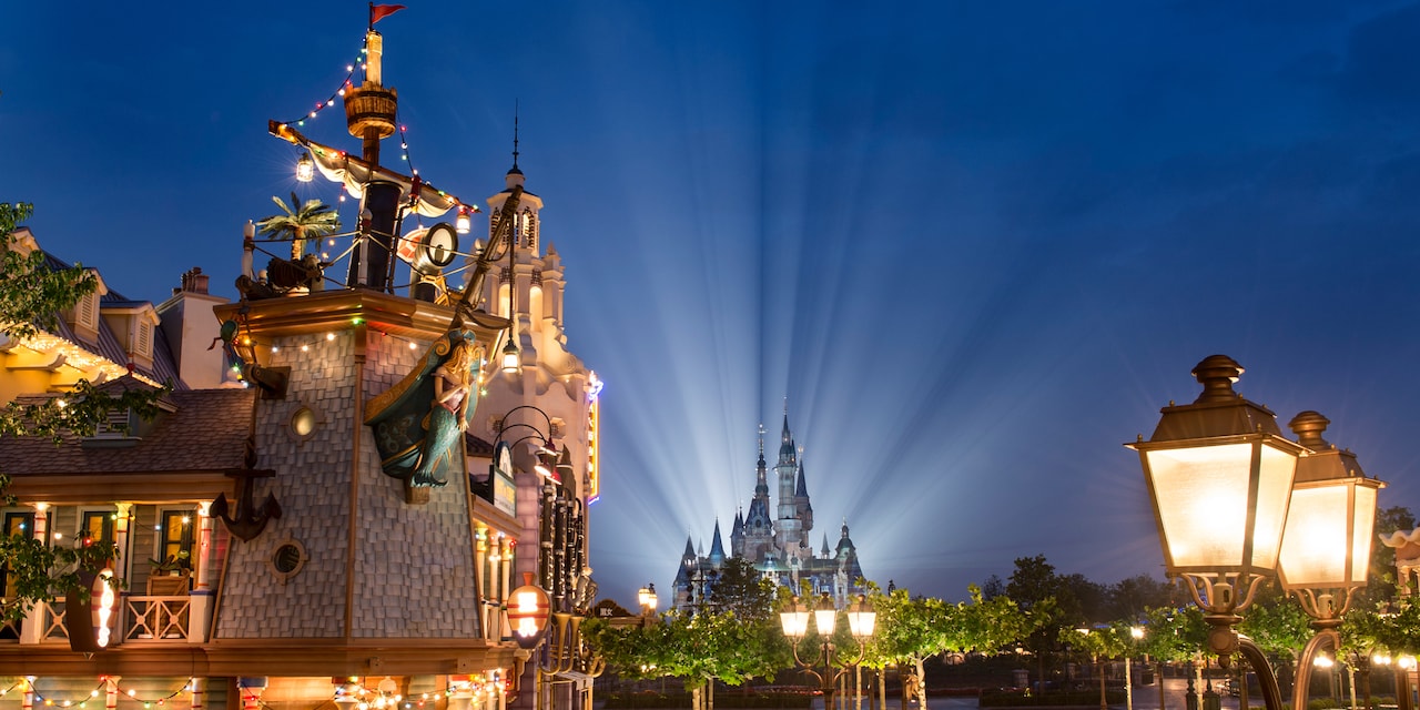 Treasure Cove and Enchanted Storybook Castle are lit up at night at Shanghai Disneyland