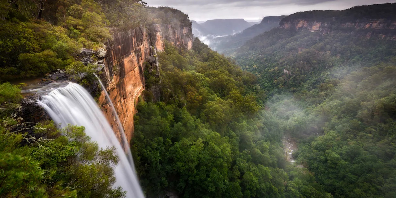 The Fitzroy Falls waterfall with surrounding bushland The Fitzroy Falls waterfall with surrounding bushland