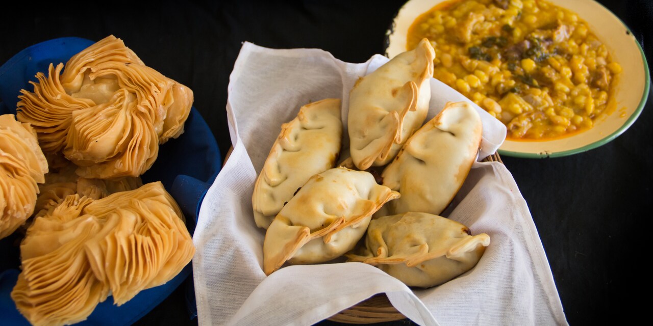 Bowl of empanadas, a bowl of corn and a plate of Argentinian pastries Bowl of empanadas, a bowl of corn and a plate of Argentinian pastries