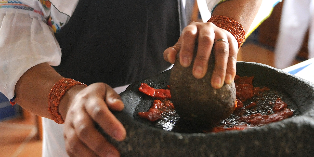 A cook prepares a traditional Ecuadorian dish A cook prepares a traditional Ecuadorian dish
