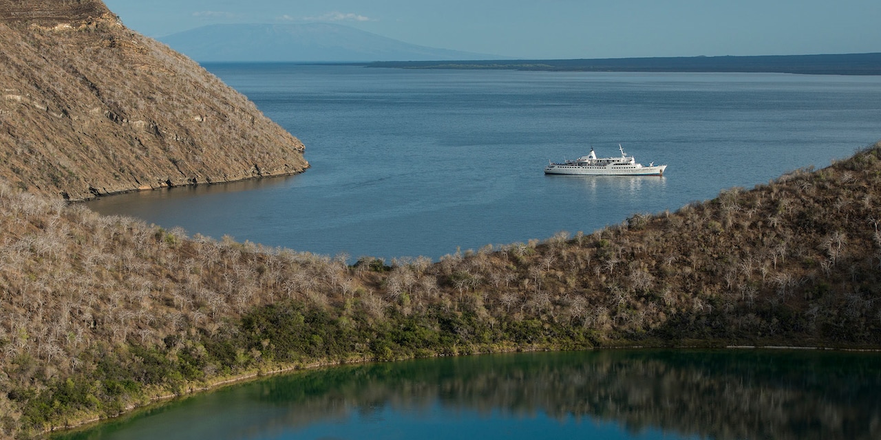 A cruise ship drifts by Tagus Cove A cruise ship drifts by Tagus Cove