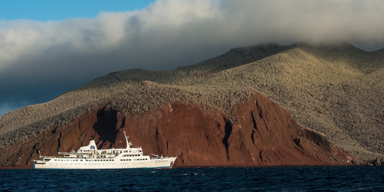 A cruise ship coasts along Rabida Island A cruise ship coasts along Rabida Island