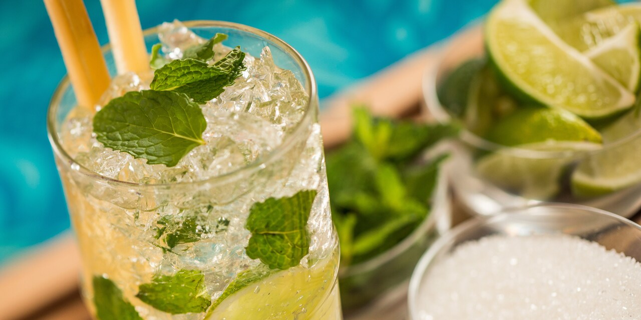 A cocktail with mint leaves and limes A cocktail with mint leaves and limes