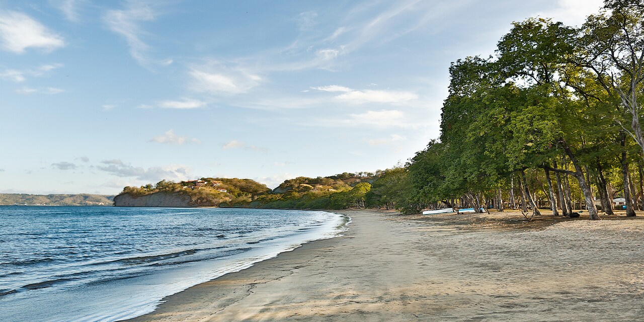 The calm waters and tree lined sands of Playa Panama in Guanacaste, Costa Rica