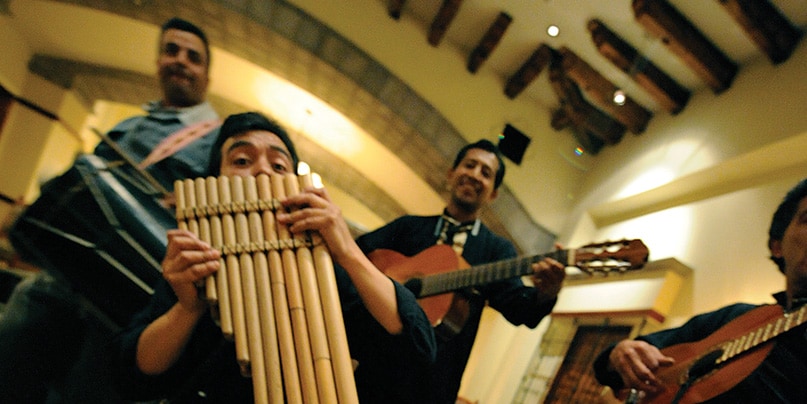 4 Ecuadorian musicians playing guitars and a pan flute 4 Ecuadorian musicians playing guitars and a pan flute