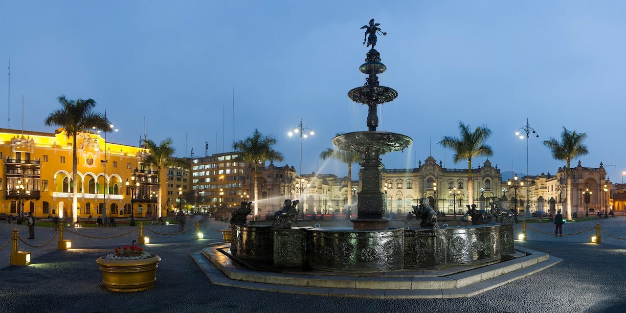 A fountain with a trumpeter at the top on the cobblestone streets of Plaza Mayor in Lima, Peru