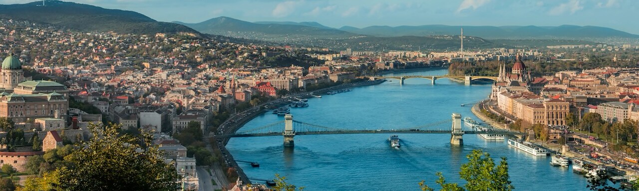 The Danube River with 2 bridges and city buildings on both shores The Danube River with 2 bridges and city buildings on both shores