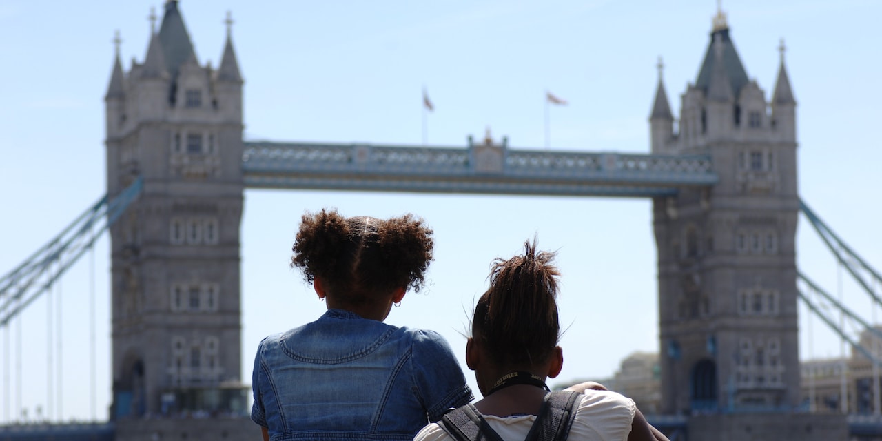 Two girls look at the Tower Bridge Two girls look at the Tower Bridge