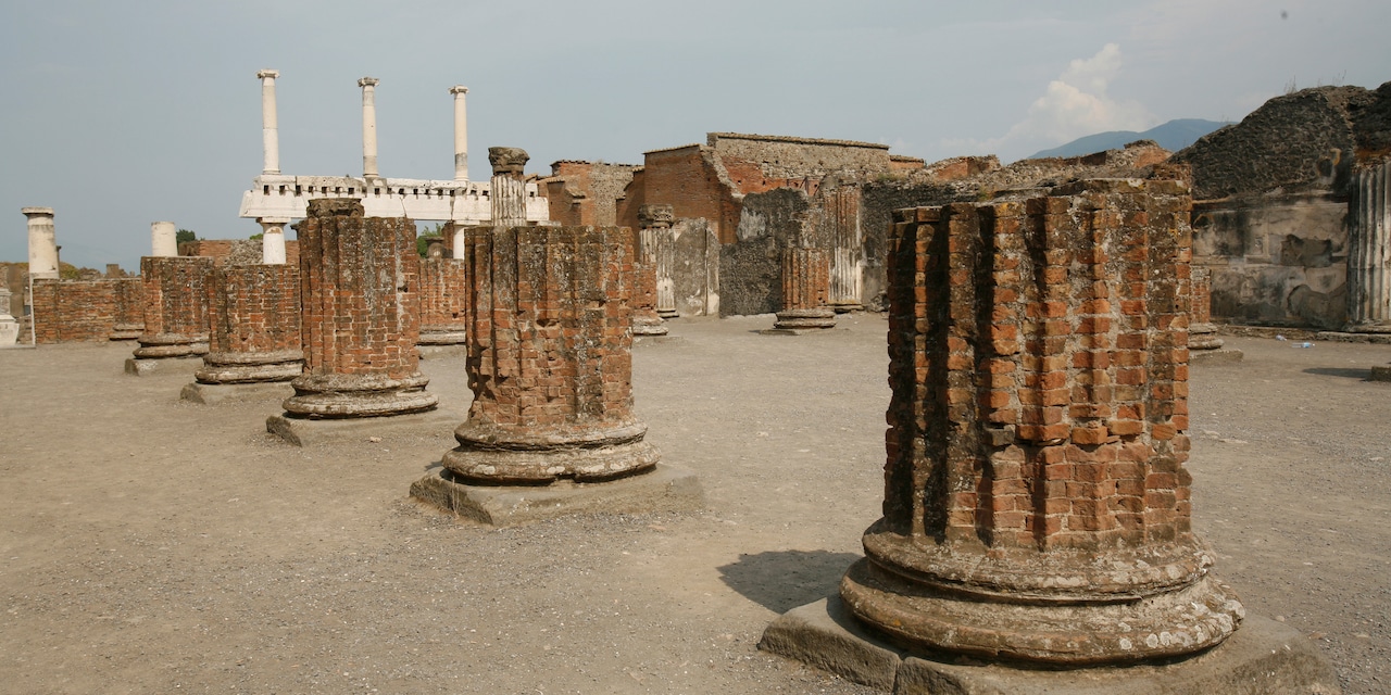 A row of large brick column bases are all that remain of a Pompeii building A row of large brick column bases are all that remain of a Pompeii building