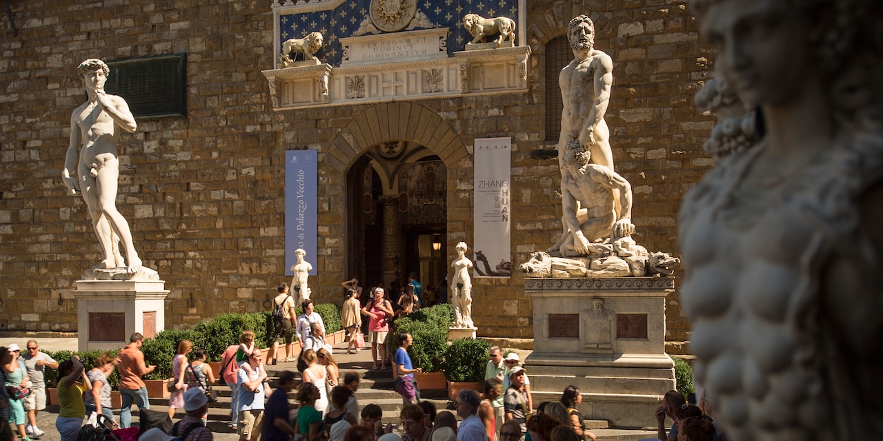A replica of Michelangelo's David and another statue outside the Palazzo Vecchio in Florence, Italy A replica of Michelangelo's David and another statue outside the Palazzo Vecchio in Florence, Italy