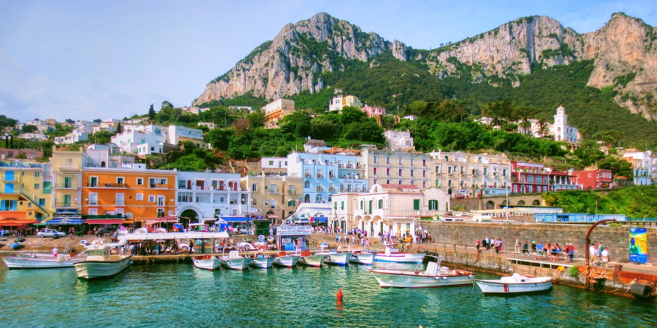 Colorful houses of Capri line the mountainside next to the sea