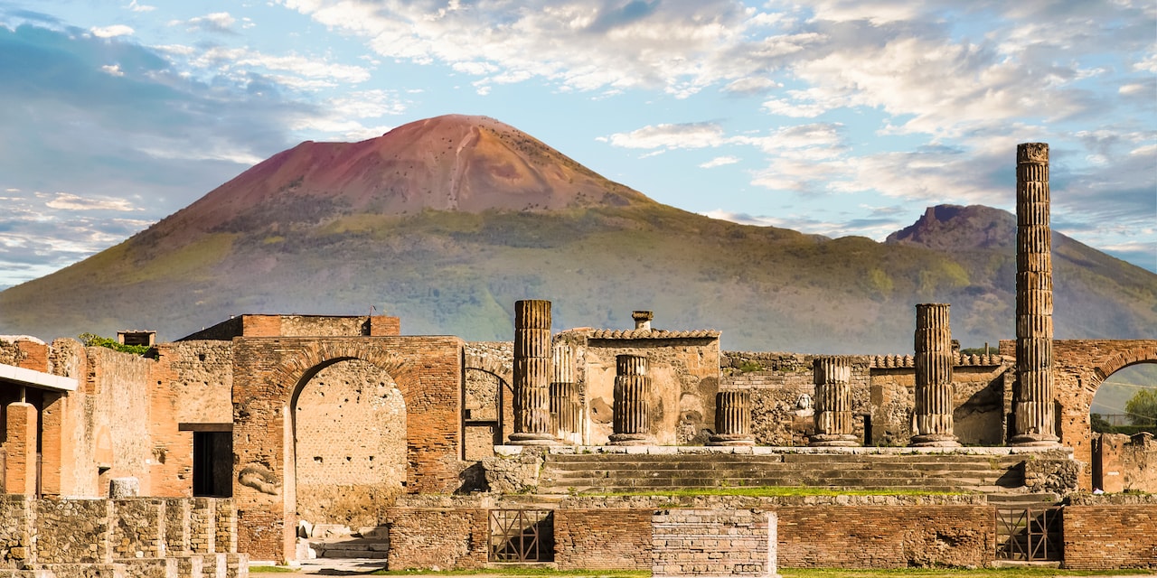 Historical Pompeii site with Mount Vesuvius in the distance