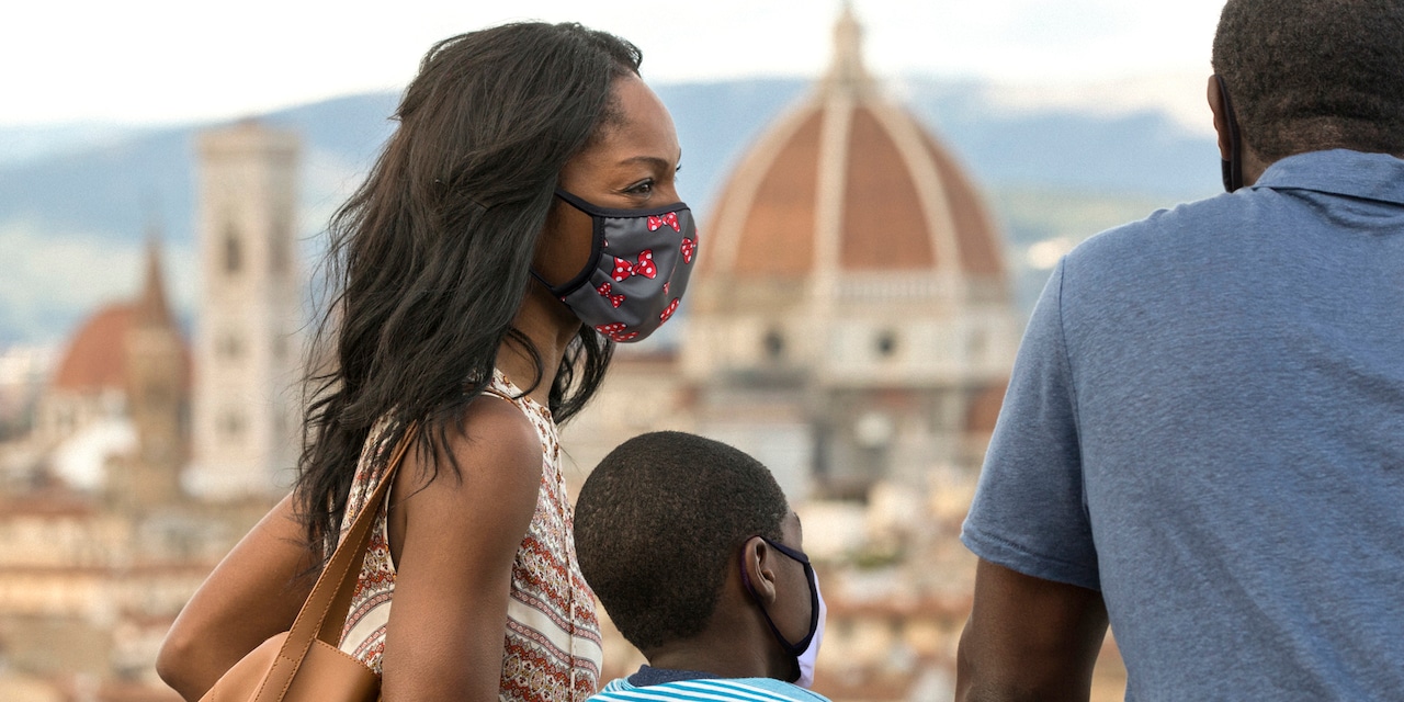 Family wearing masks stand on terrace overlooking the city of Florence Family wearing masks stand on terrace overlooking the city of Florence