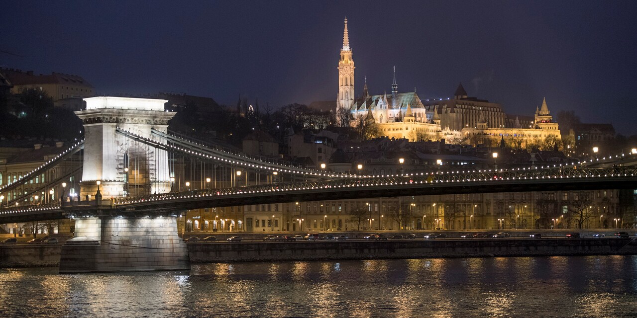  The Széchenyi Chain Bridge lit up at night spans the Danube River
