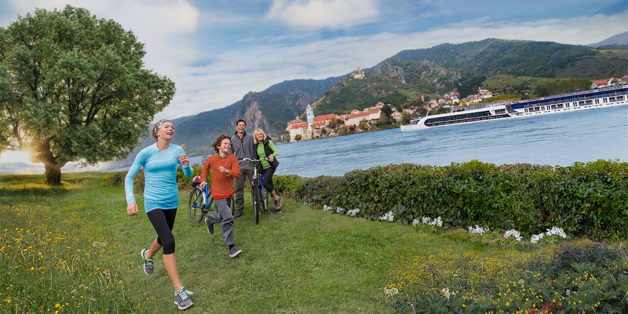 A boy and a girl run past their parents who are standing with bicycles next to the bank of the Danube River A boy and a girl run past their parents who are standing with bicycles next to the bank of the Danube River