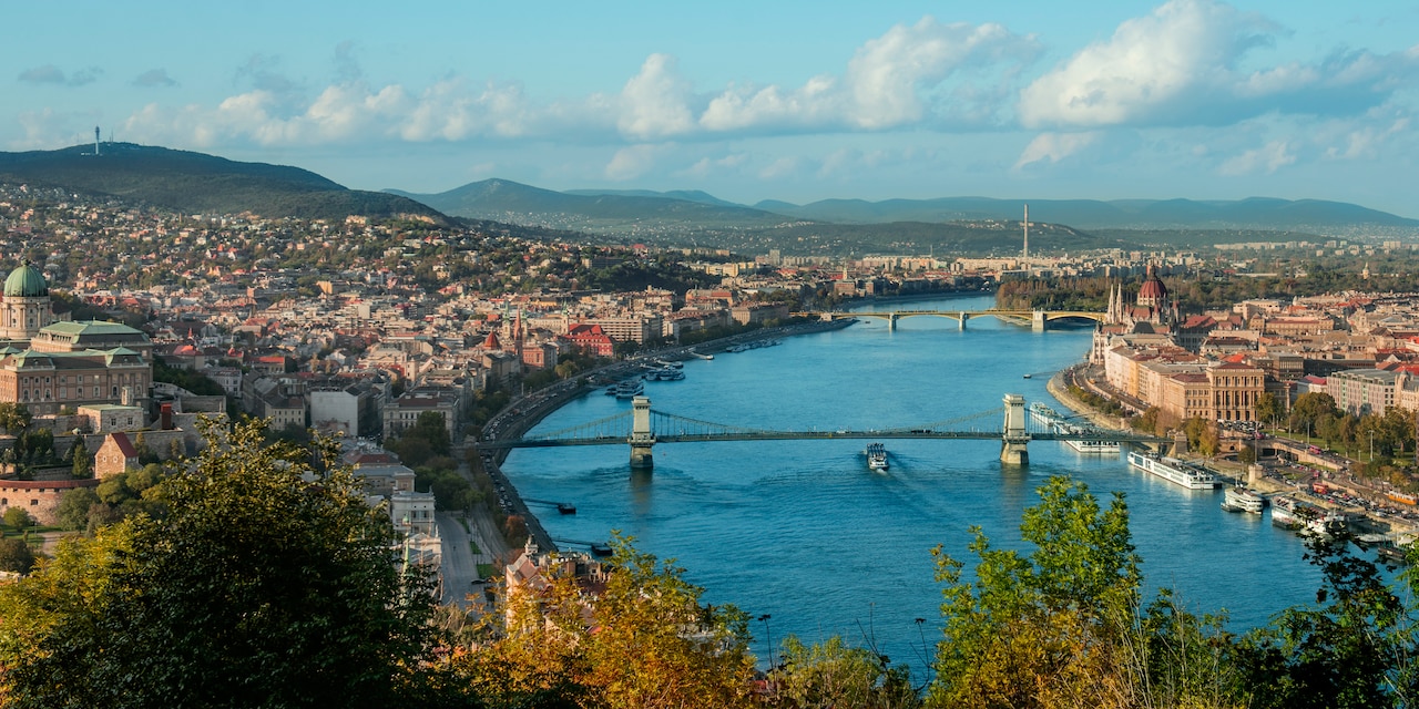 The Danube River with 2 bridges and city buildings on both shores The Danube River with 2 bridges and city buildings on both shores