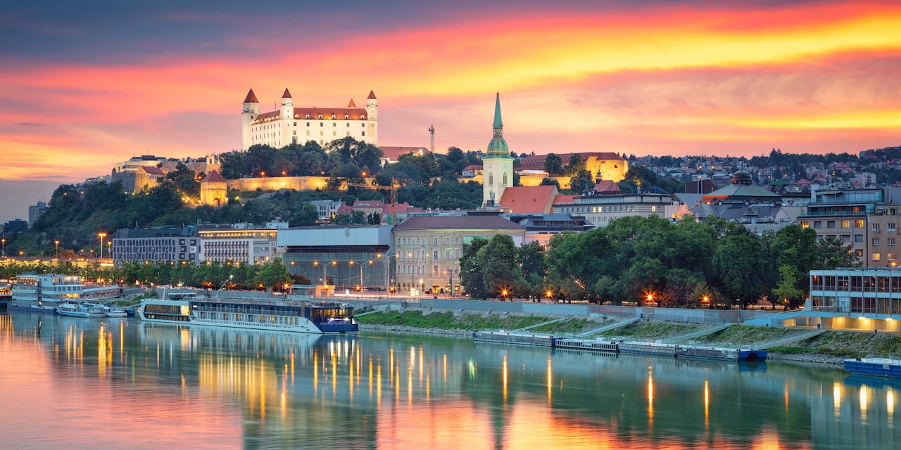 Sunset reflecting on the Danube River with Schloss Hof Palace on the hill overlooking the city below