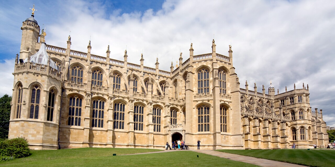 The entrance to the majestic Windsor Castle surrounded by manicured lawns The entrance to the majestic Windsor Castle surrounded by manicured lawns