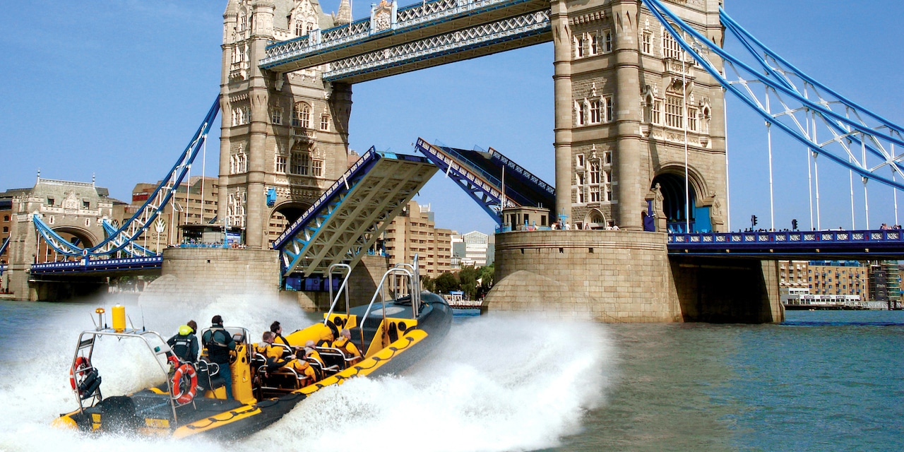 A speedboat races towards Tower Bridge on the River Thames A speedboat races towards Tower Bridge on the River Thames