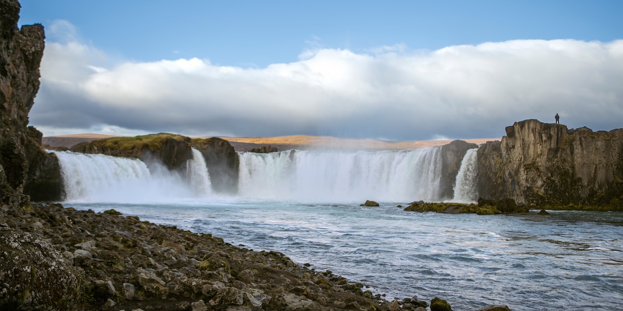 A picture of Goðafoss Waterfall taken from the banks of the water