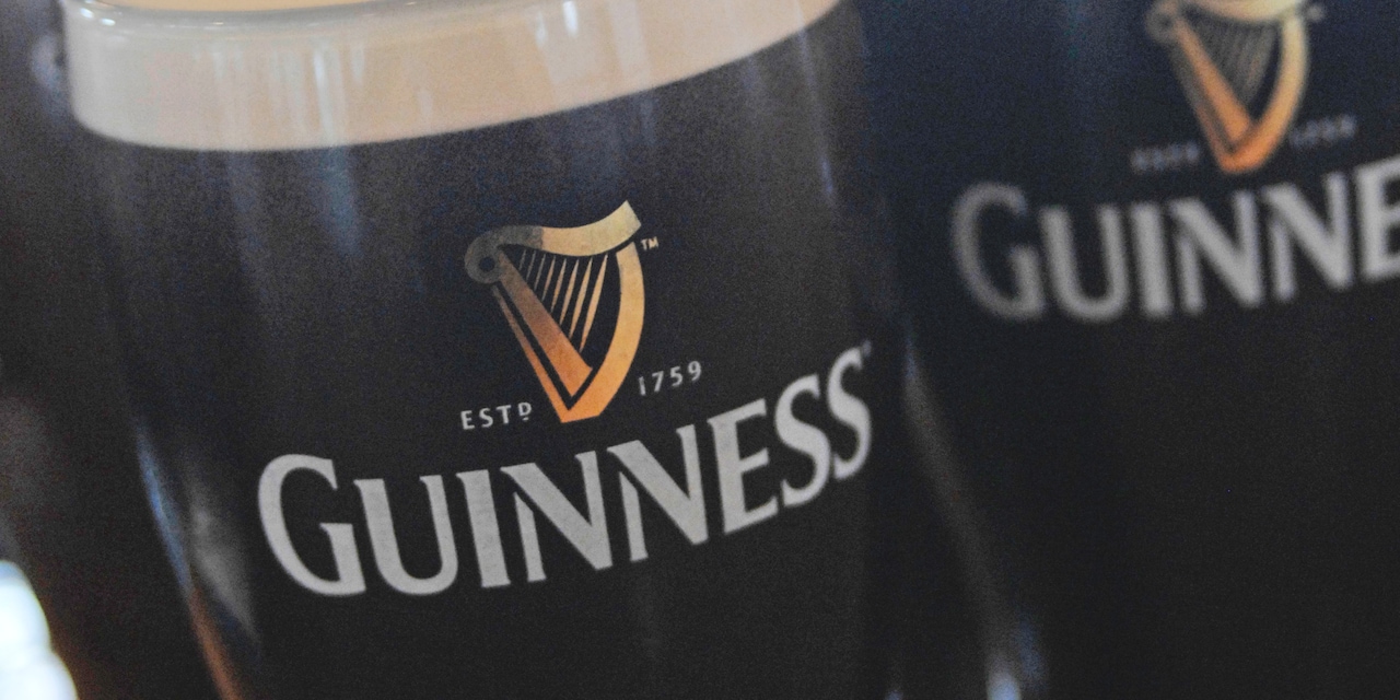 A stein filled with dark beer reads 'Guinness, Est. 1759'
A stein filled with dark beer reads 'Guinness, Est. 1759'