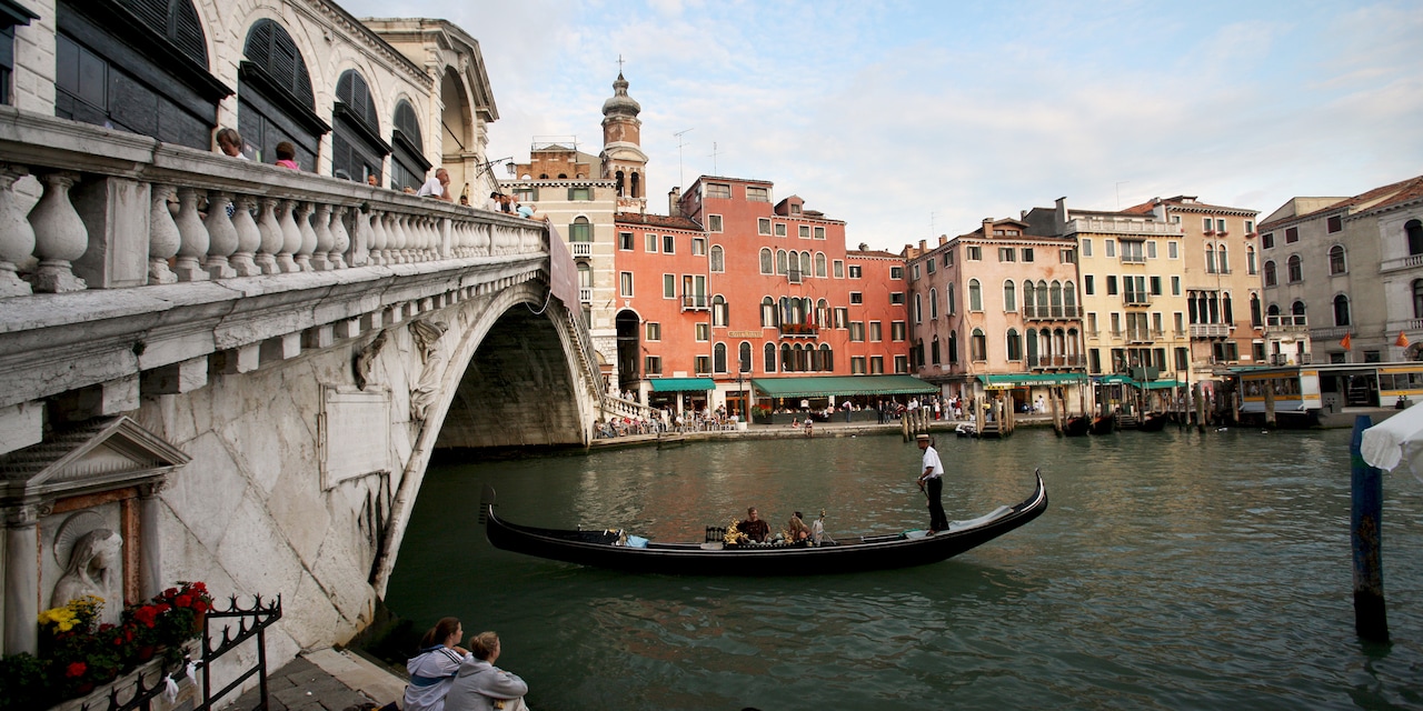 A gondola glides under a bridge in Venice, Italy