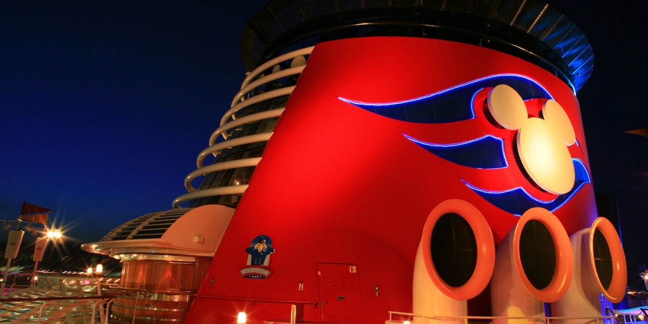 The funnel of the Disney Magic cruise ship with a Mickey Mouse logo The funnel of the Disney Magic cruise ship with a Mickey Mouse logo