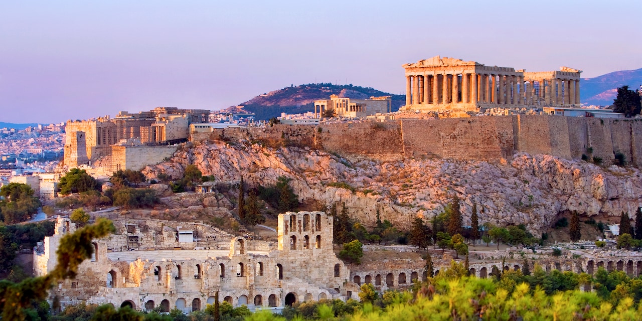 The Parthenon and other ancient ruins atop the Acropolis in Athens, Greece The Parthenon and other ancient ruins atop the Acropolis in Athens, Greece