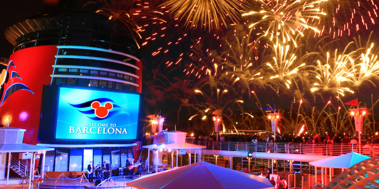 Fireworks over the deck of the Disney Magic Ship and a sign reading 'Welcome to Barcelona' Fireworks over the deck of the Disney Magic Ship and a sign reading 'Welcome to Barcelona'