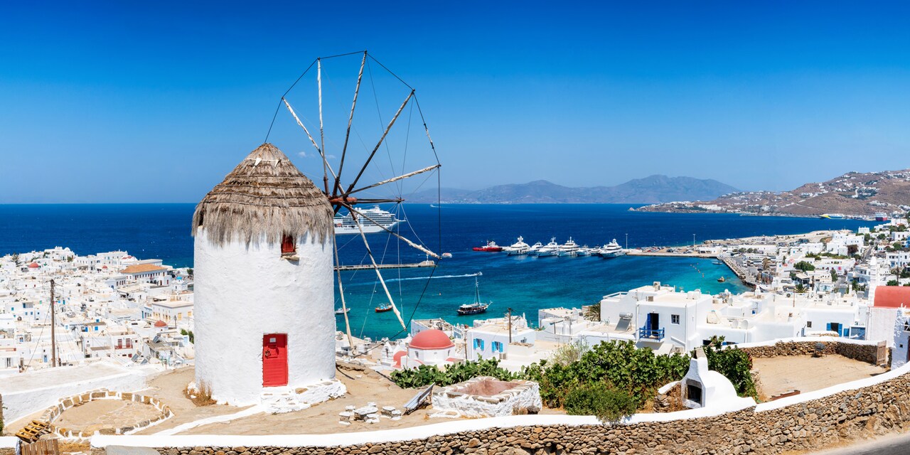 A windmill with a thatched roof in a sea-side town on the Greek island of Mykonos A windmill with a thatched roof in a sea-side town on the Greek island of Mykonos