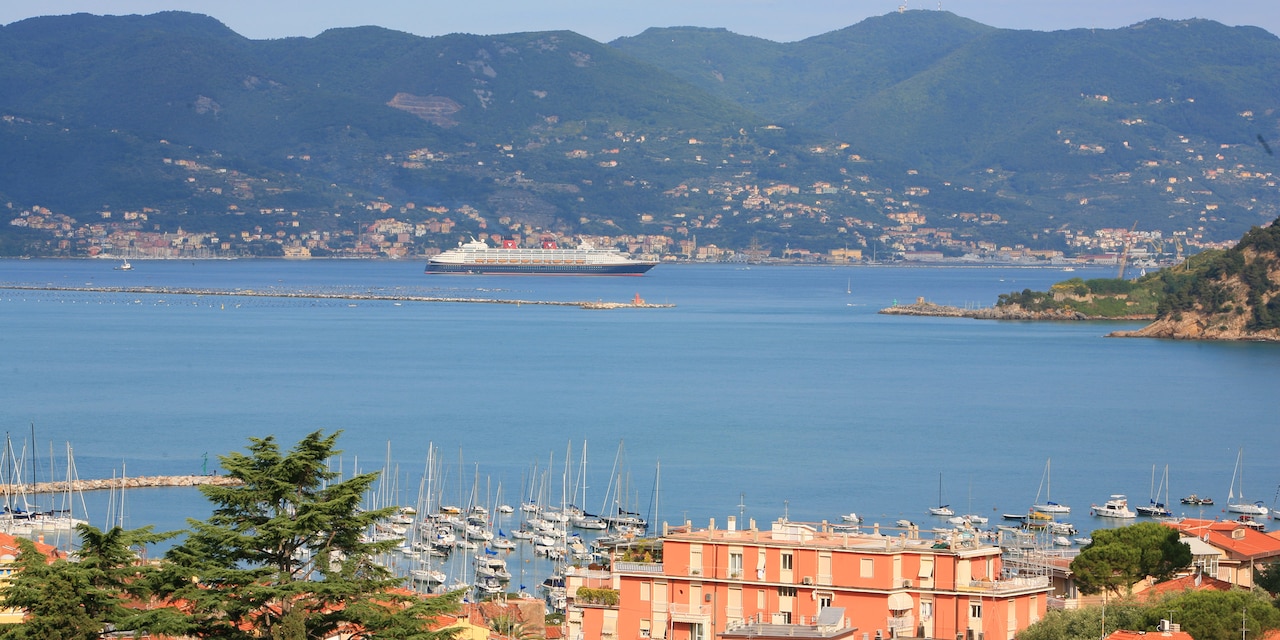 The Disney Magic cruise ship sails near the hilly shores of Florence, Italy The Disney Magic cruise ship sails near the hilly shores of Florence, Italy