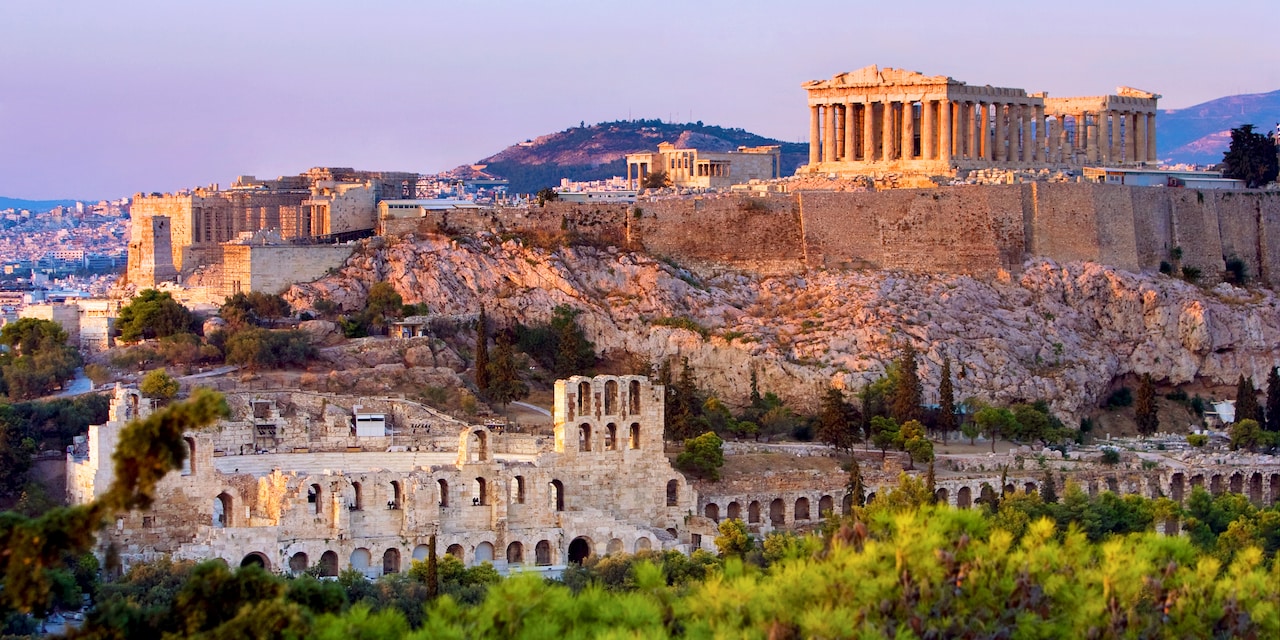 The Parthenon atop the Acropolis looks over the city of Athens, Greece The Parthenon atop the Acropolis looks over the city of Athens, Greece