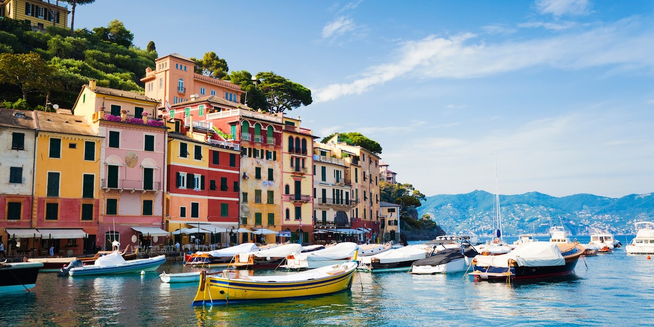 Boats moored in the building-lined waters of the town of Genoa, Italy Boats moored in the building-lined waters of the town of Genoa, Italy