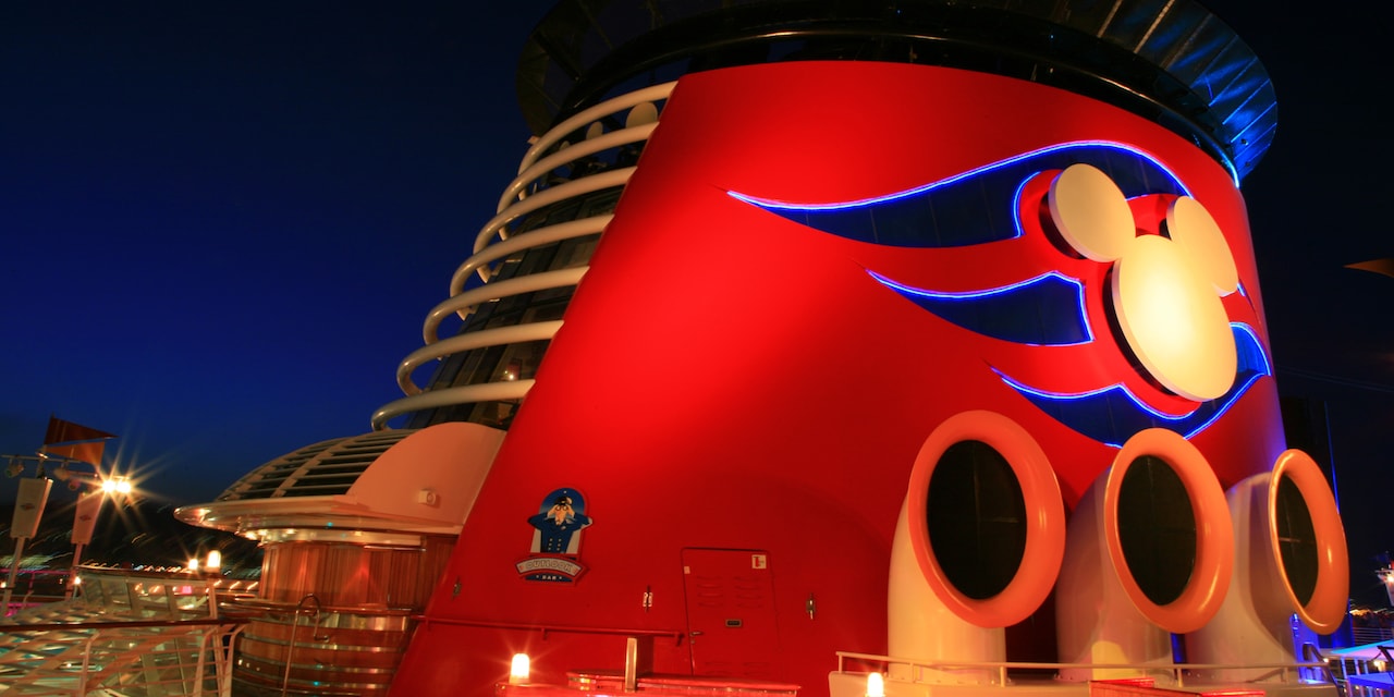 The Forward Funnel with a Mickey Mouse logo on the top deck of the Disney Magic cruise ship The Forward Funnel with a Mickey Mouse logo on the top deck of the Disney Magic cruise ship