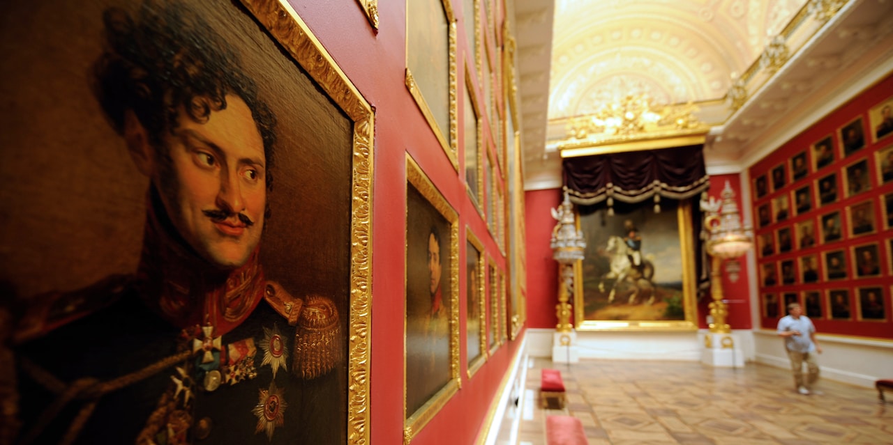 A portrait of a mustached military man on a wall lined with painted portraits in a gallery room in the Hermitage Museum A portrait of a mustached military man on a wall lined with painted portraits in a gallery room in the Hermitage Museum