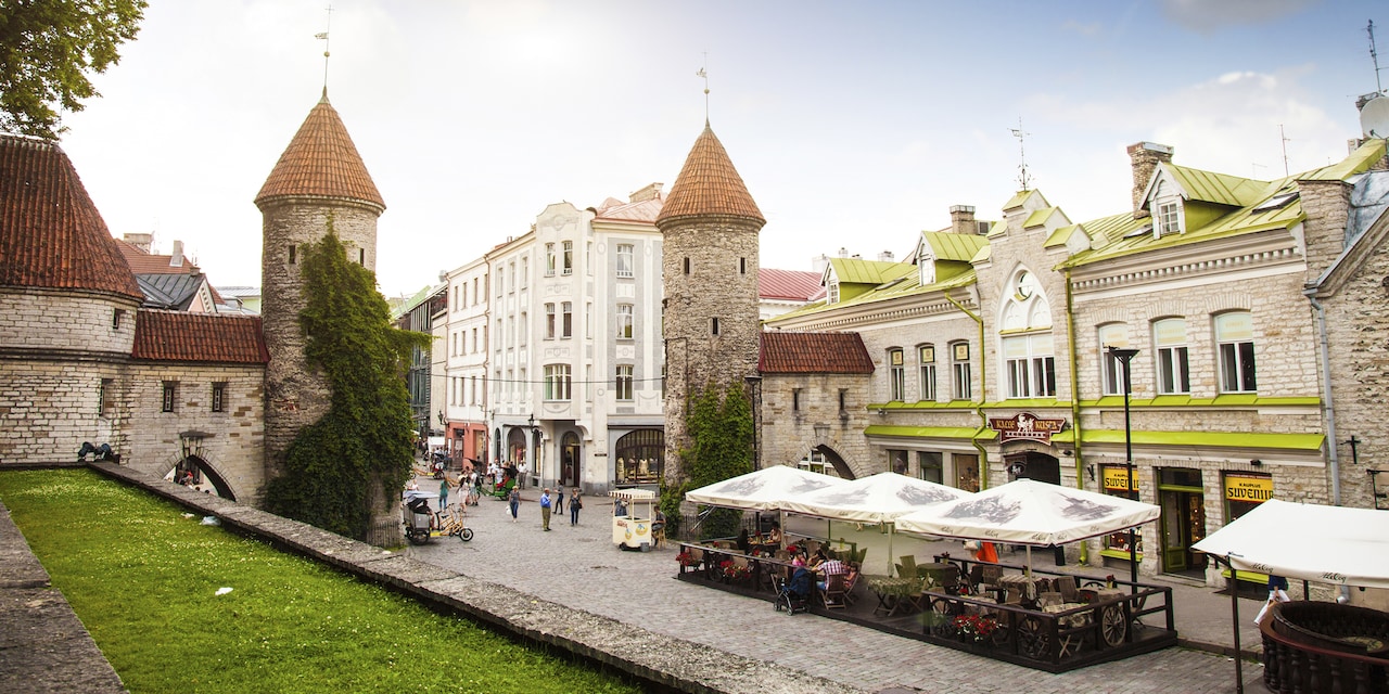 Two spired structures along a building-lined street form the entryway to Old Town Tallinn, Estonia Two spired structures along a building-lined street form the entryway to Old Town Tallinn, Estonia