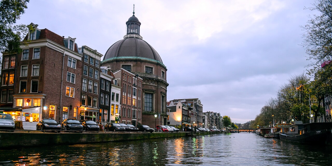 Buildings line the bank of a river