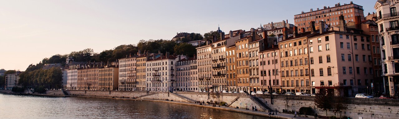 Buildings line the shores of the Rhône River Buildings line the shores of the Rhône River