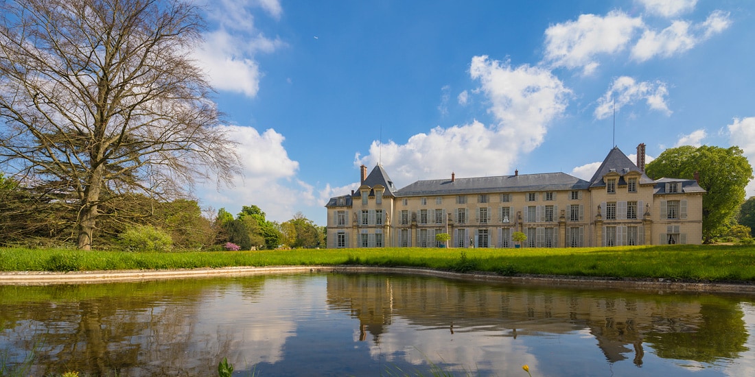 The French castle, Chateau Malmaison, sits just beyond a nearby pond