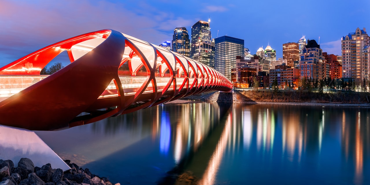 The modern Calgary footbridge with the city’s skyline in the background at night