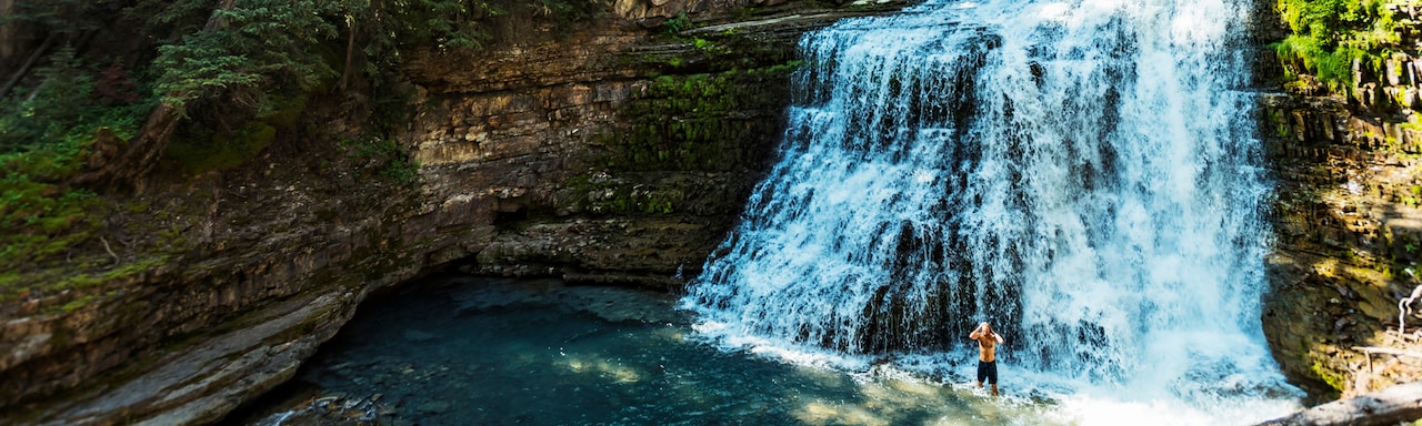 an standing in shallow water at the base of Ousel Falls an standing in shallow water at the base of Ousel Falls