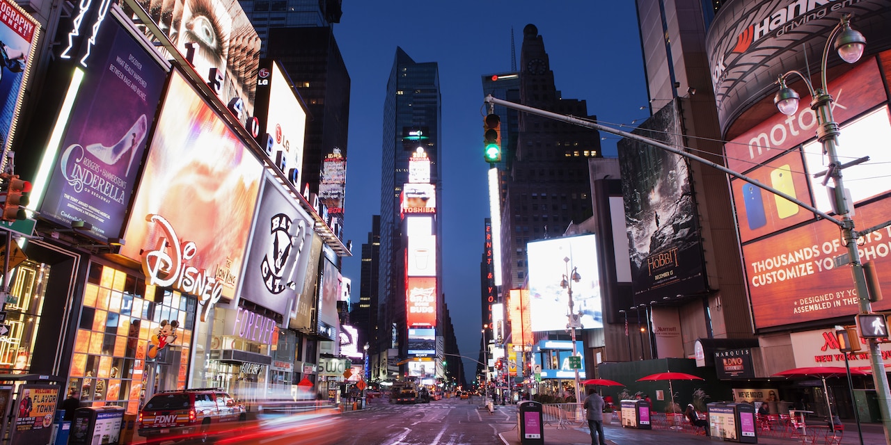 The brightly lit buildings of Times Square at night The brightly lit buildings of Times Square at night