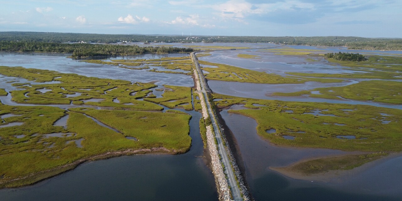 A long road stretches over the a marsh area in Halfiax, Nova Scotia