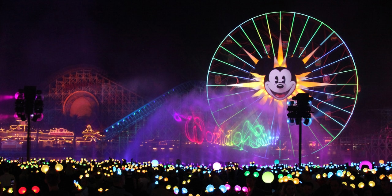 A crowd of people wearing light-up Mickey Mouse ears watch the colors and mists of the World of Color show by Mickey’s Fun Wheel at Disney California Adventure A crowd of people wearing light-up Mickey Mouse ears watch the colors and mists of the World of Color show by Mickey’s Fun Wheel at Disney California Adventure
