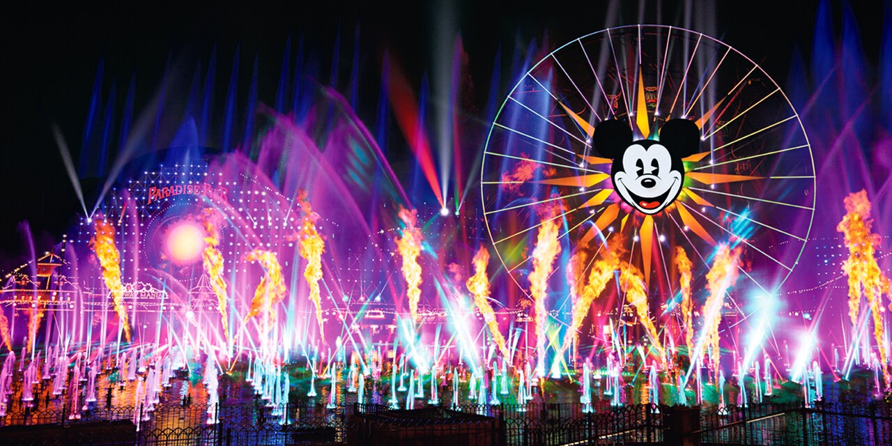 Multicolor lights and fountains with the Pixar-Pal-Around attraction in the background