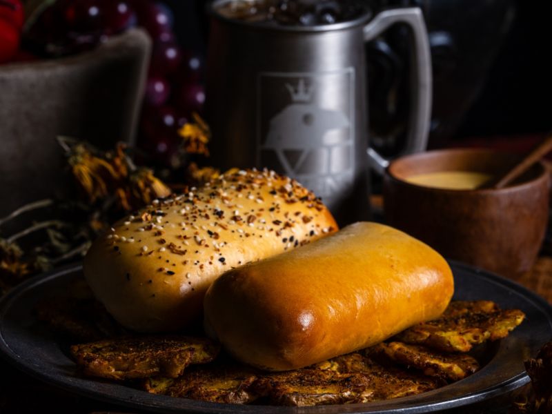 Housemade yeast rolls known as Coffyns sitting on a platter near a bowl and a metal mug at Six Ravens