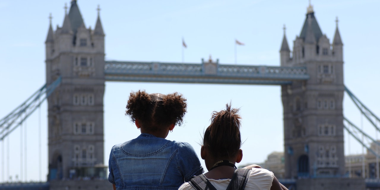 Two girls look at the Tower Bridge
