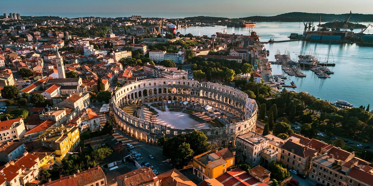 An aerial view of the seaside city of Pula, Croatia featuring Pula Arena 