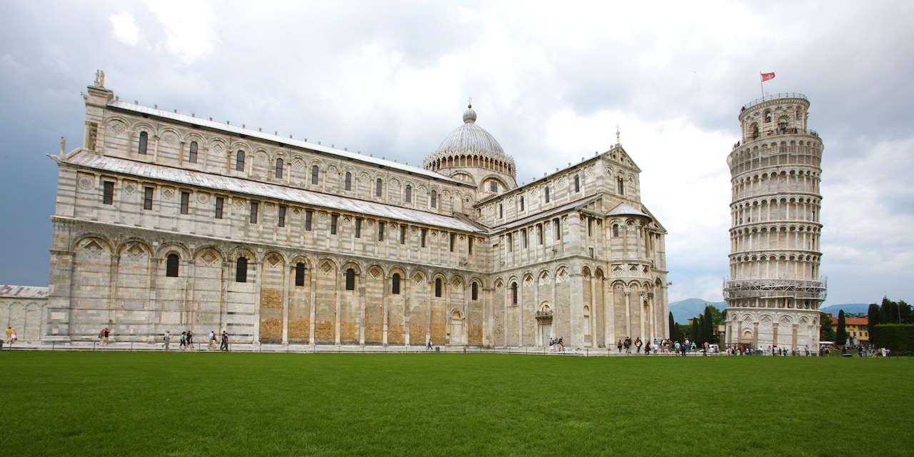 The Pisa Cathedral with its domed top and the Leaning Tower of Pisa beside it in Cathedral Square